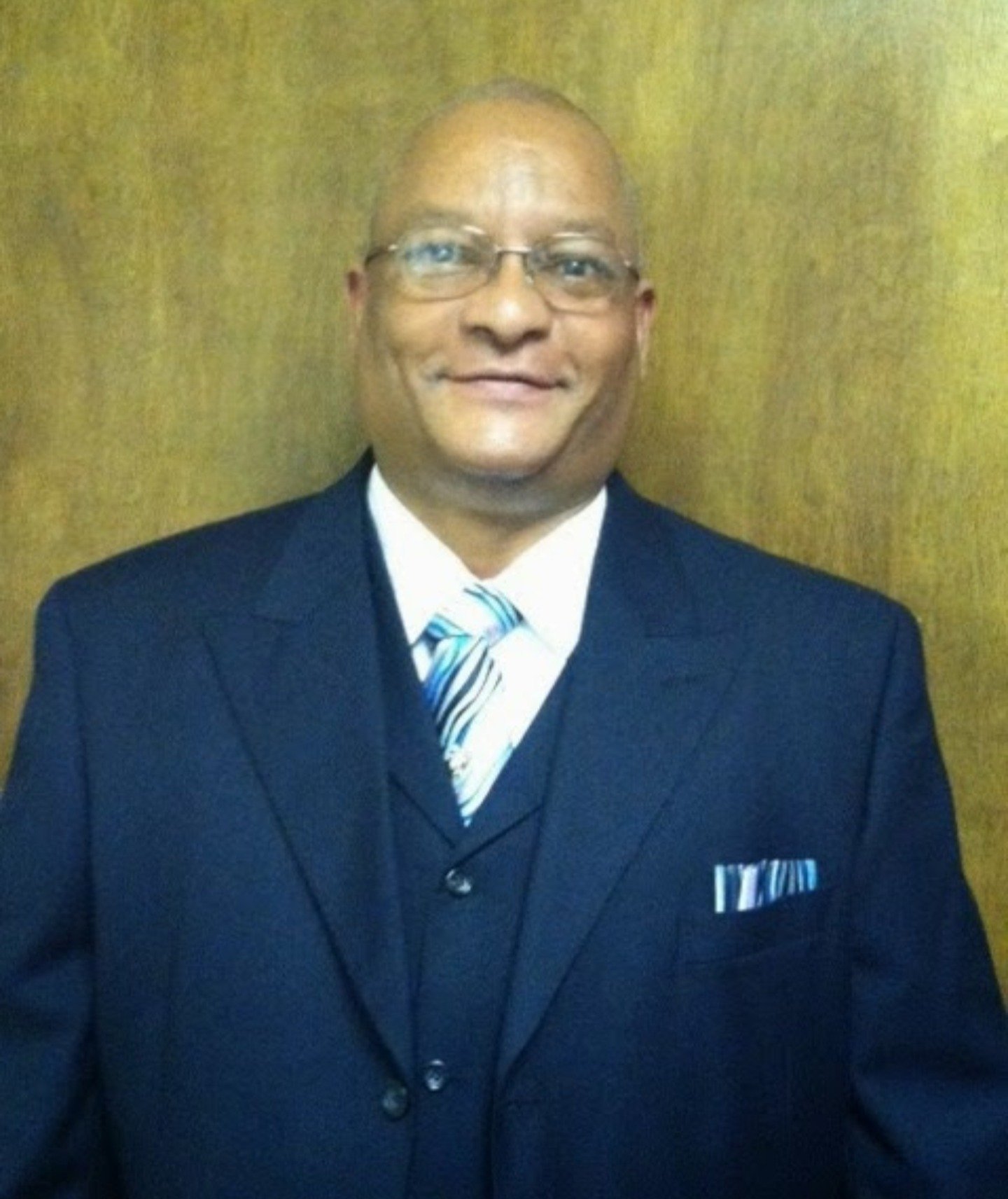 Red in Blue suit with blue & white tie